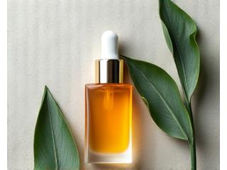 Botol serum dengan titisan keemasan dan daun kecil